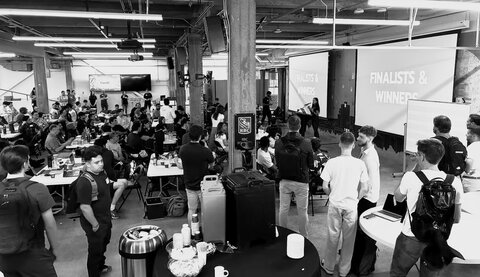 Students presenting hackathon results on stage