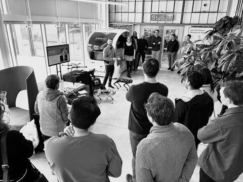 An engineer demonstrating hardware to a group