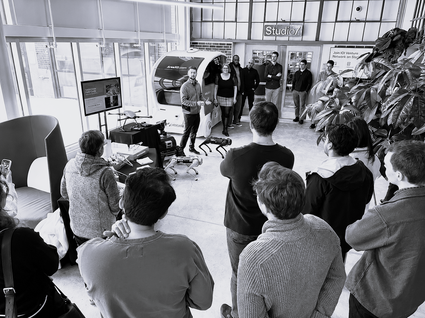 An engineer demonstrating hardware to a group